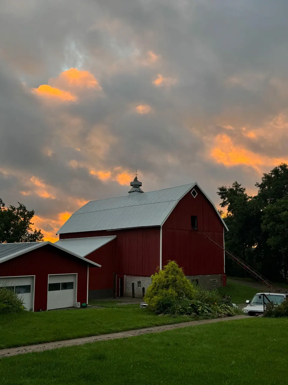 A red barn with white trim we painted in Greenfield, at sunset